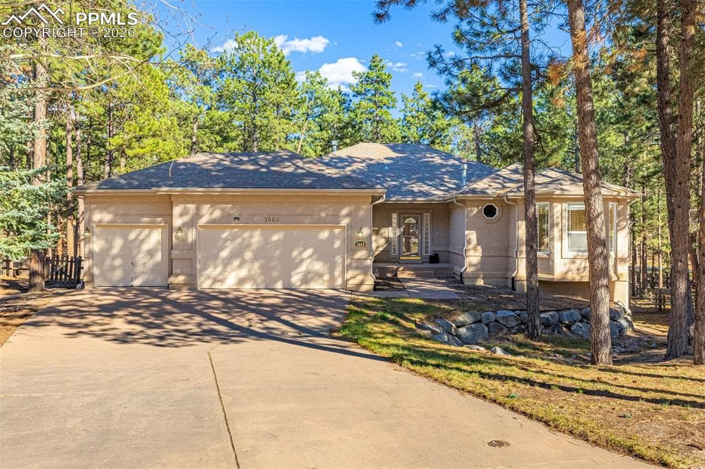 The property features an attached 3-car garage, a concrete driveway, and a welcoming front entrance