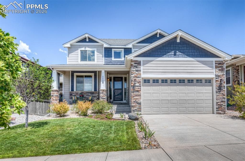 Two-story residence featuring a combination of horizontal siding, shake siding, and stone veneer accents