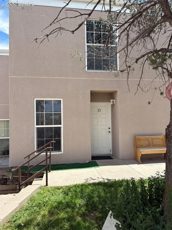 View of exterior entry featuring stucco siding