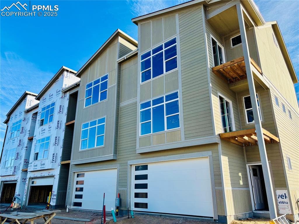 Rear view of property featuring a garage
