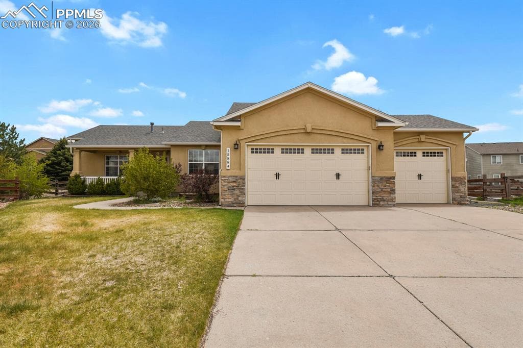 Single-story stucco exterior with stone accents and a covered front porch